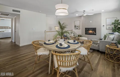 a living room with furniture a clock and a flat screen tv