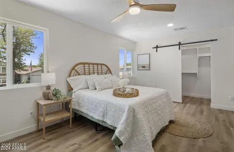 a bedroom with a bed and wooden floor