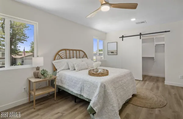 a bedroom with a bed and wooden floor
