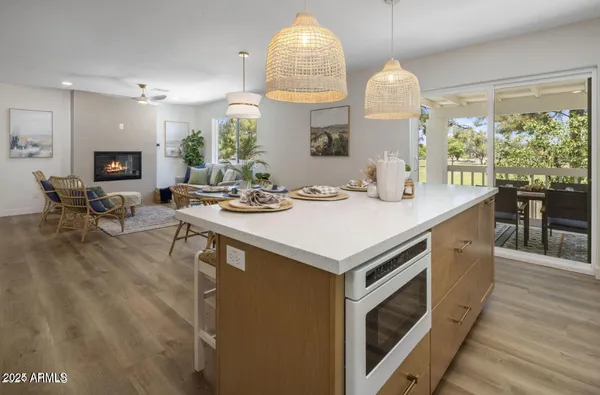 a kitchen that has a lot of cabinets and wooden floor