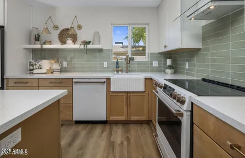a kitchen with a sink a stove and cabinets