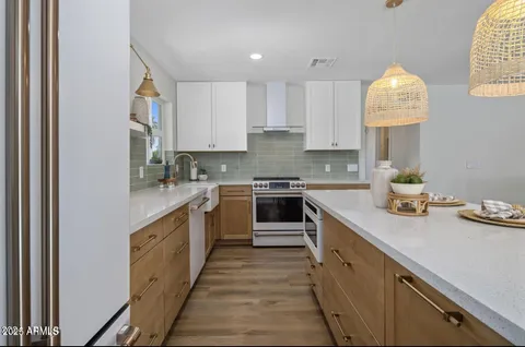 a kitchen with a sink stove and cabinets