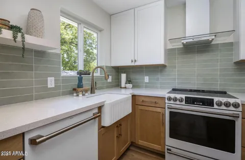 a kitchen with a sink cabinets and window
