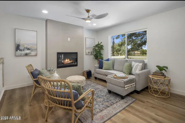 a living room with furniture a fireplace and a flat screen tv
