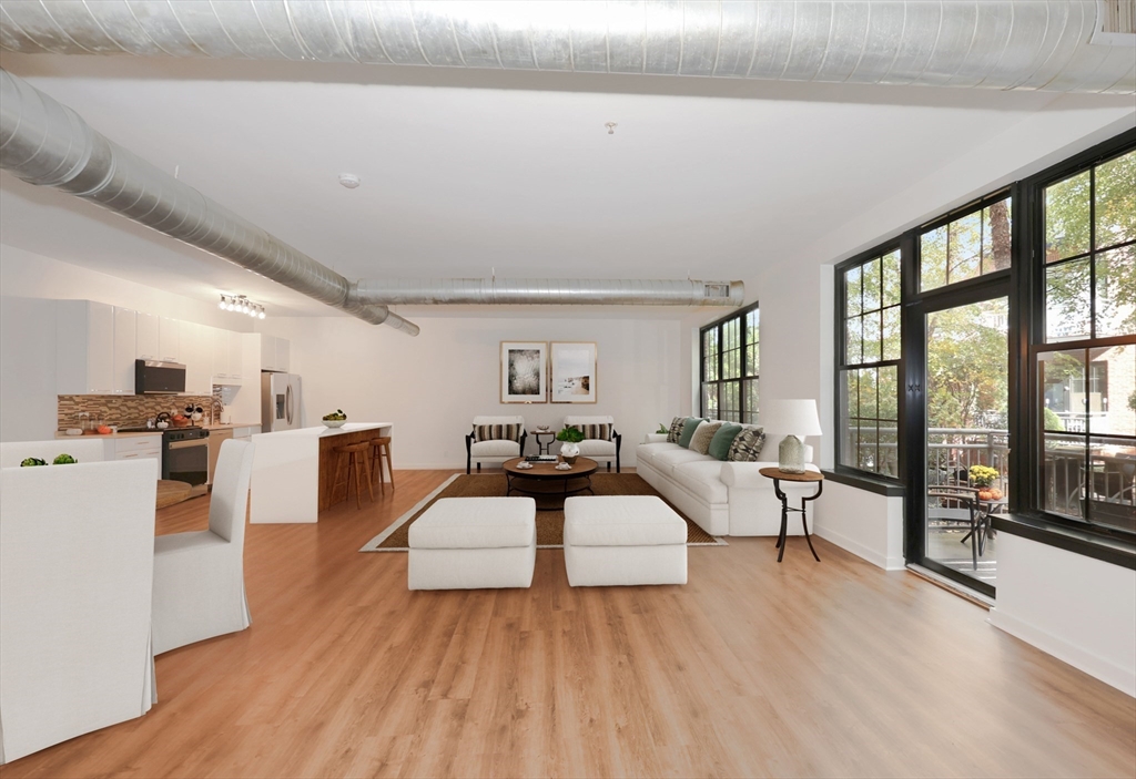 944 Dorchester Avenue, Unit 9 Boston, MA 02125 - Photo 2 of 29 a living room with furniture and a table