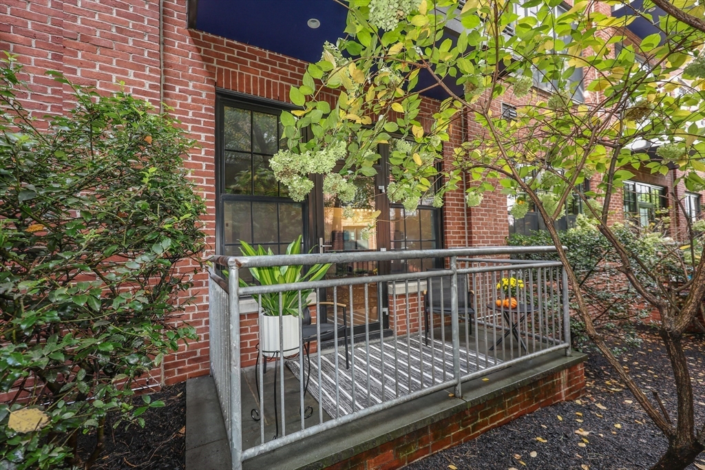 944 Dorchester Avenue, Unit 9 Boston, MA 02125 - Photo 7 of 29 a view of balcony with wooden floor and fence