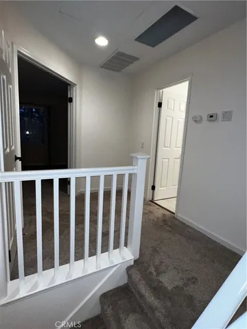 an empty room with window and pillar in it