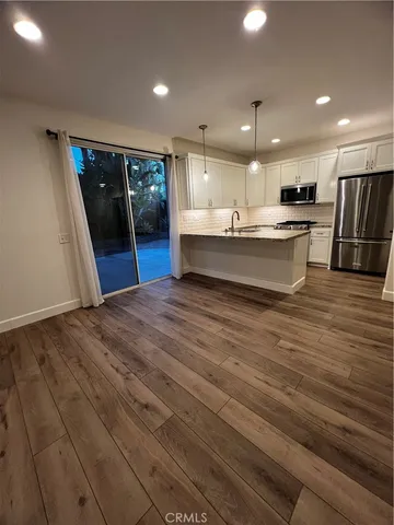 a large kitchen with stainless steel appliances kitchen island a large counter top and a sink