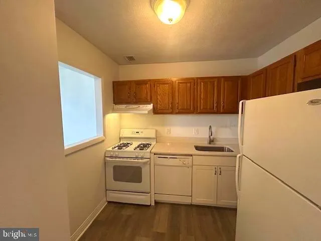 a kitchen with a stove a sink and a microwave