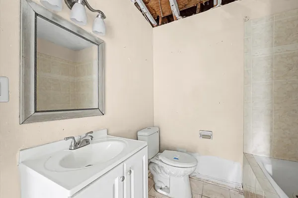a bathroom with a sink toilet and mirror