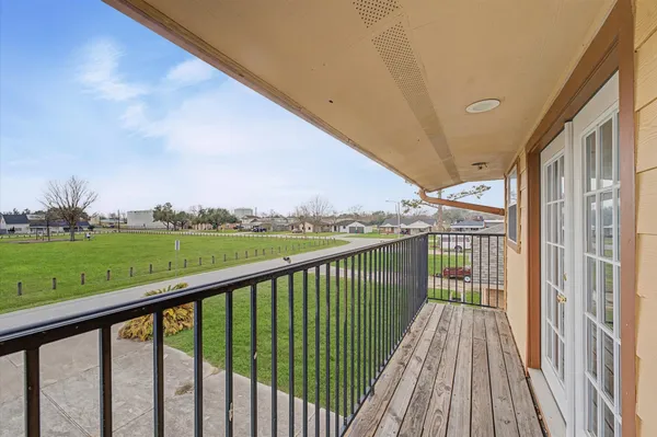 a view of balcony with yard
