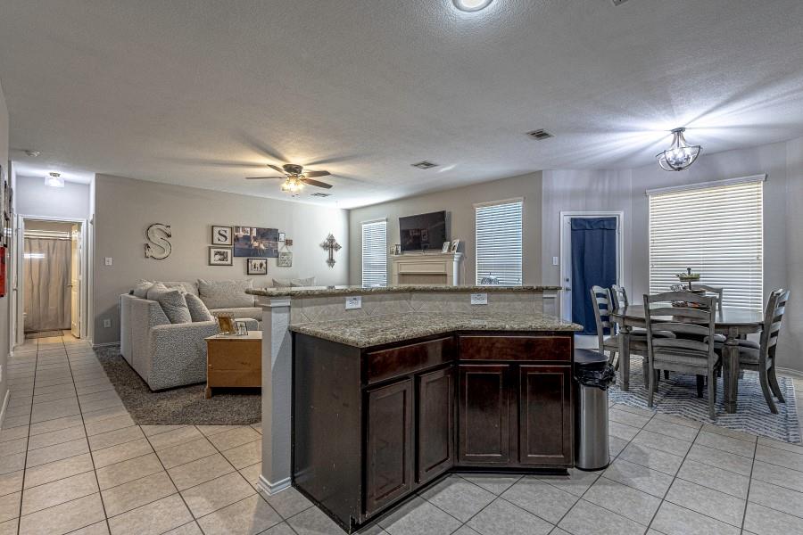 10165 China Creek Drive Waco, TX 76708 - Photo 36 of 36 a kitchen with granite countertop a sink and a stove