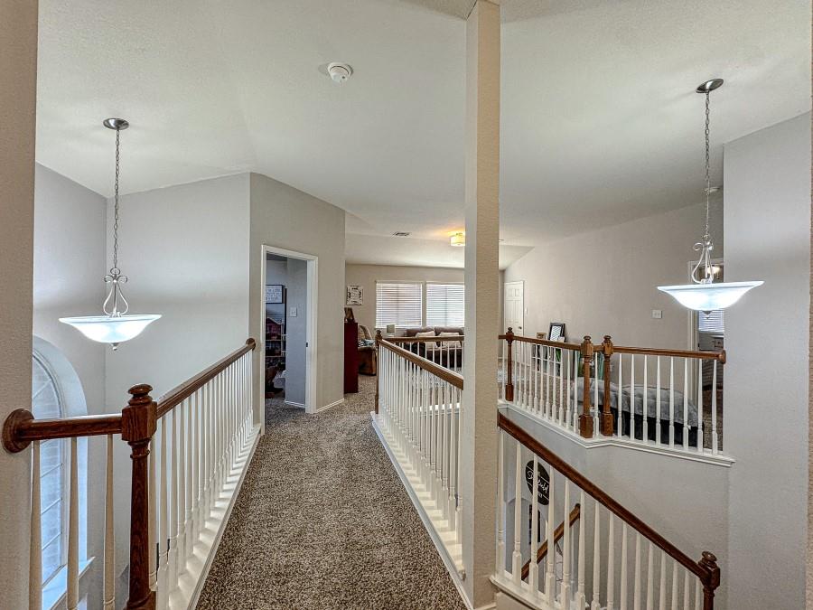 10165 China Creek Drive Waco, TX 76708 - Photo 19 of 36 a view of a hallway with a chandelier