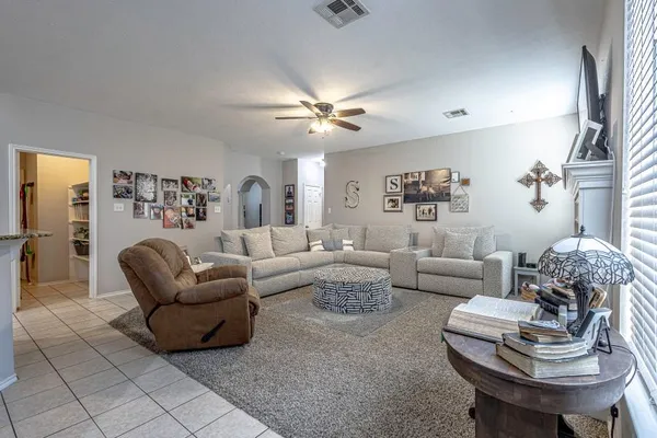 a living room with lots of furniture and kitchen view