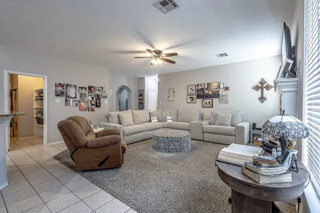 a living room with lots of furniture and kitchen view