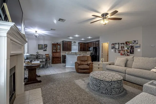 a living room with furniture a chandelier and a rug