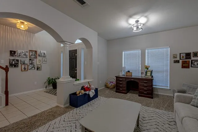 a living room with stainless steel appliances granite countertop furniture wooden floor and a view of kitchen