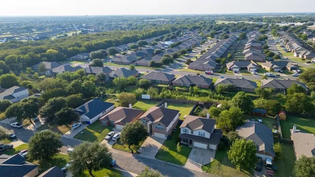 an aerial view of residential houses with outdoor space