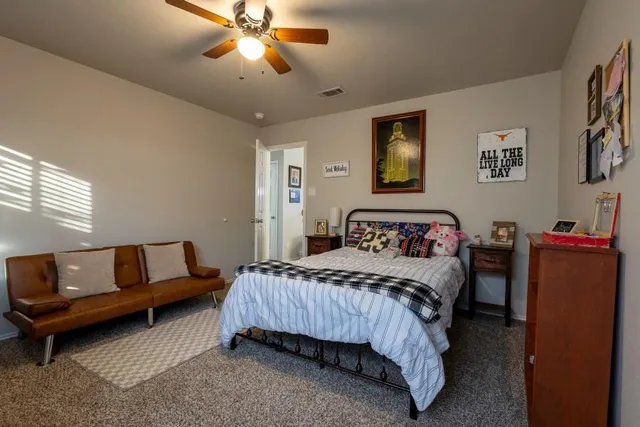 a bedroom with furniture and a window