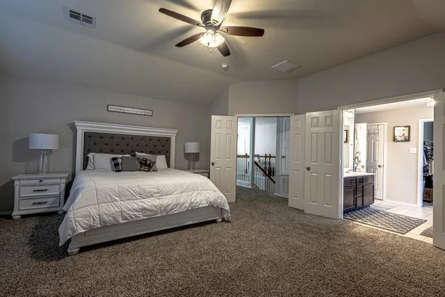 a bedroom with a bed and a view of closet
