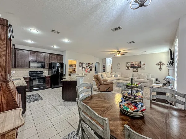 a kitchen with granite countertop a table and chairs