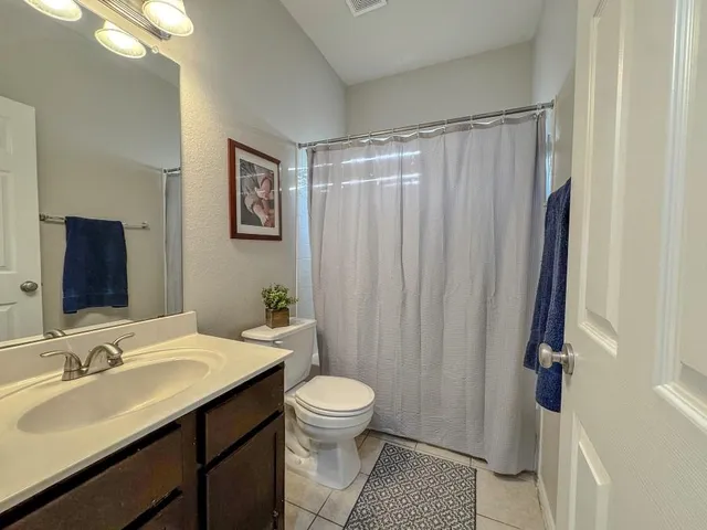a living room with lots of furniture and kitchen view