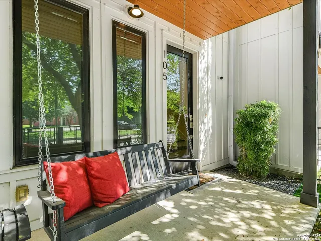 a balcony with furniture and a potted plant