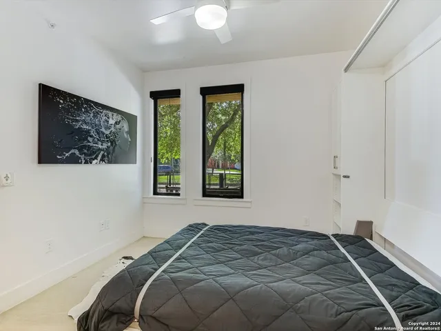 a bed sitting in a bedroom next to a window