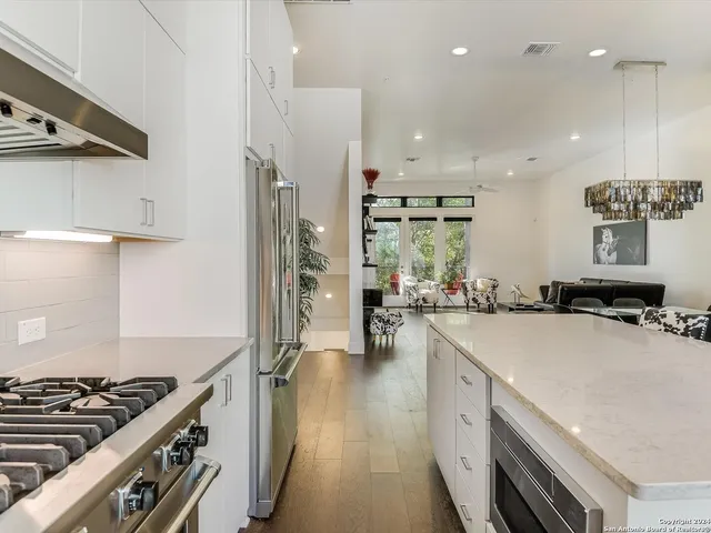 a kitchen with a stove a sink and a refrigerator