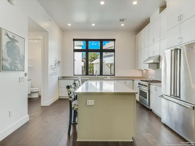 a kitchen with a refrigerator and a sink