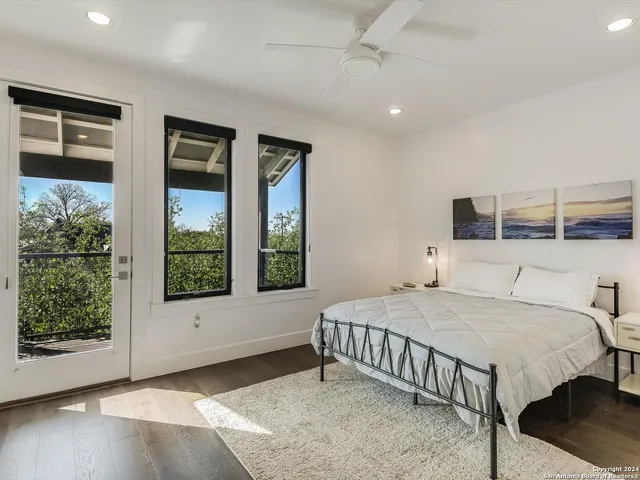 a bedroom with a large bed and a window