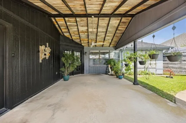 an aerial view of a house with swimming pool and outdoor seating