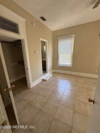 a view of an empty room with a window