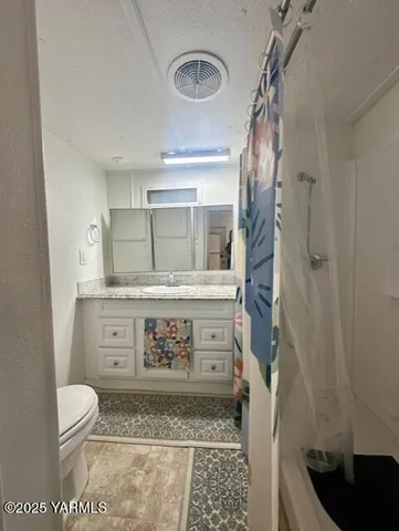 a bathroom with a toilet and a shower