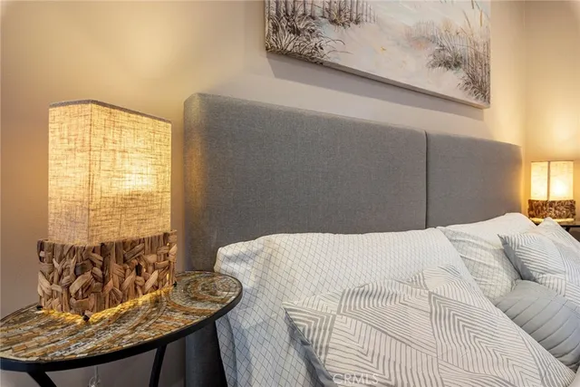 a bedroom with a large bed and a flat screen tv