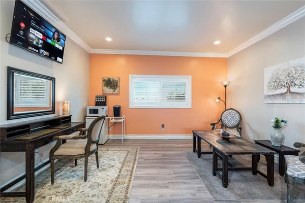 a view of a a dining room with furniture window and wooden floor