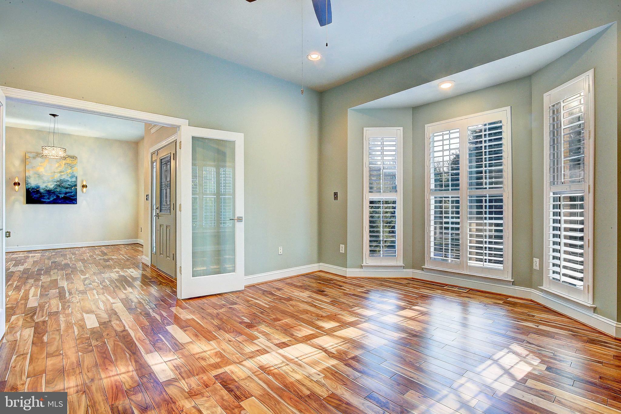 3300 Holland Cliffs Road Huntingtown, MD 20639 - Photo 35 of 93 a view of a big room with wooden floor and windows