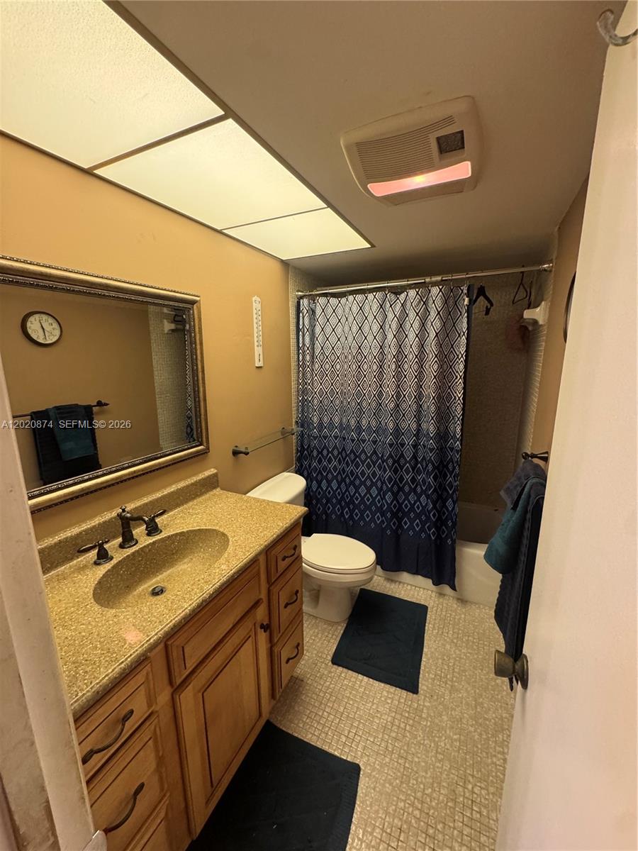 6731 Cypress Road, Unit 410 Plantation, FL 33317 - Photo 9 of 15 a bathroom with a sink a toilet a mirror and shower