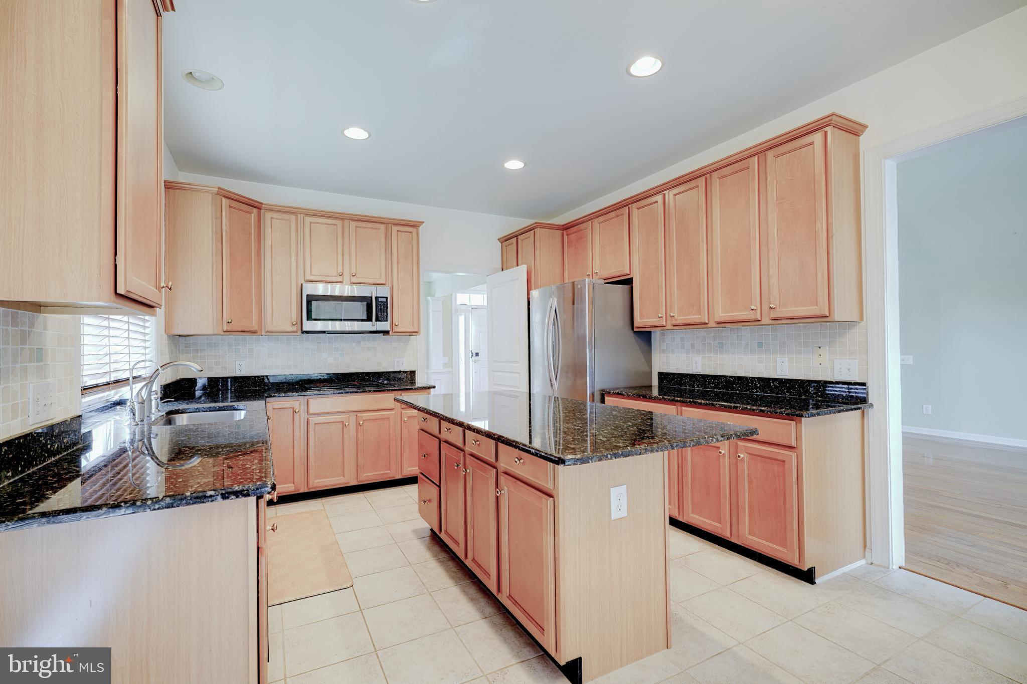 15 Ridings Way West Chester, PA 19382 - Photo 14 of 41 a kitchen with stainless steel appliances granite countertop a refrigerator and a stove top oven