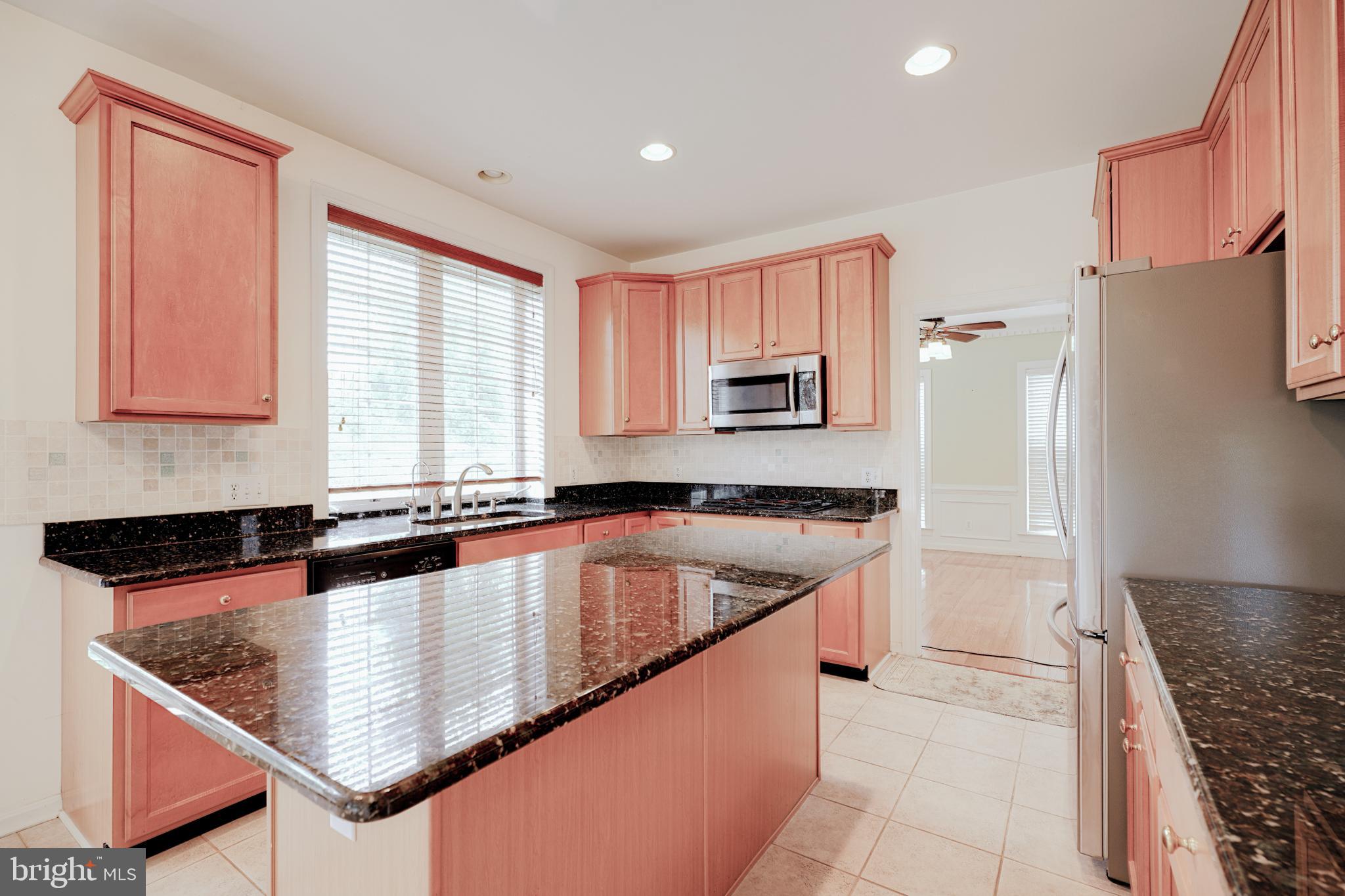 15 Ridings Way West Chester, PA 19382 - Photo 15 of 41 a kitchen with stainless steel appliances granite countertop a sink a stove and a refrigerator
