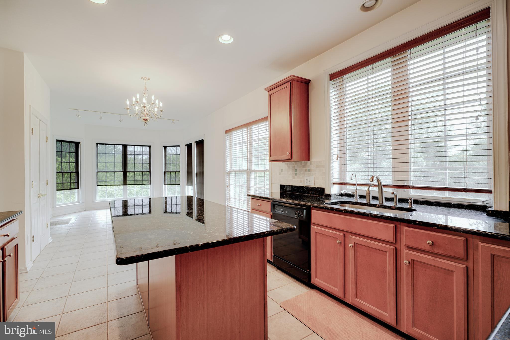 15 Ridings Way West Chester, PA 19382 - Photo 16 of 41 a kitchen with granite countertop a sink and white cabinets