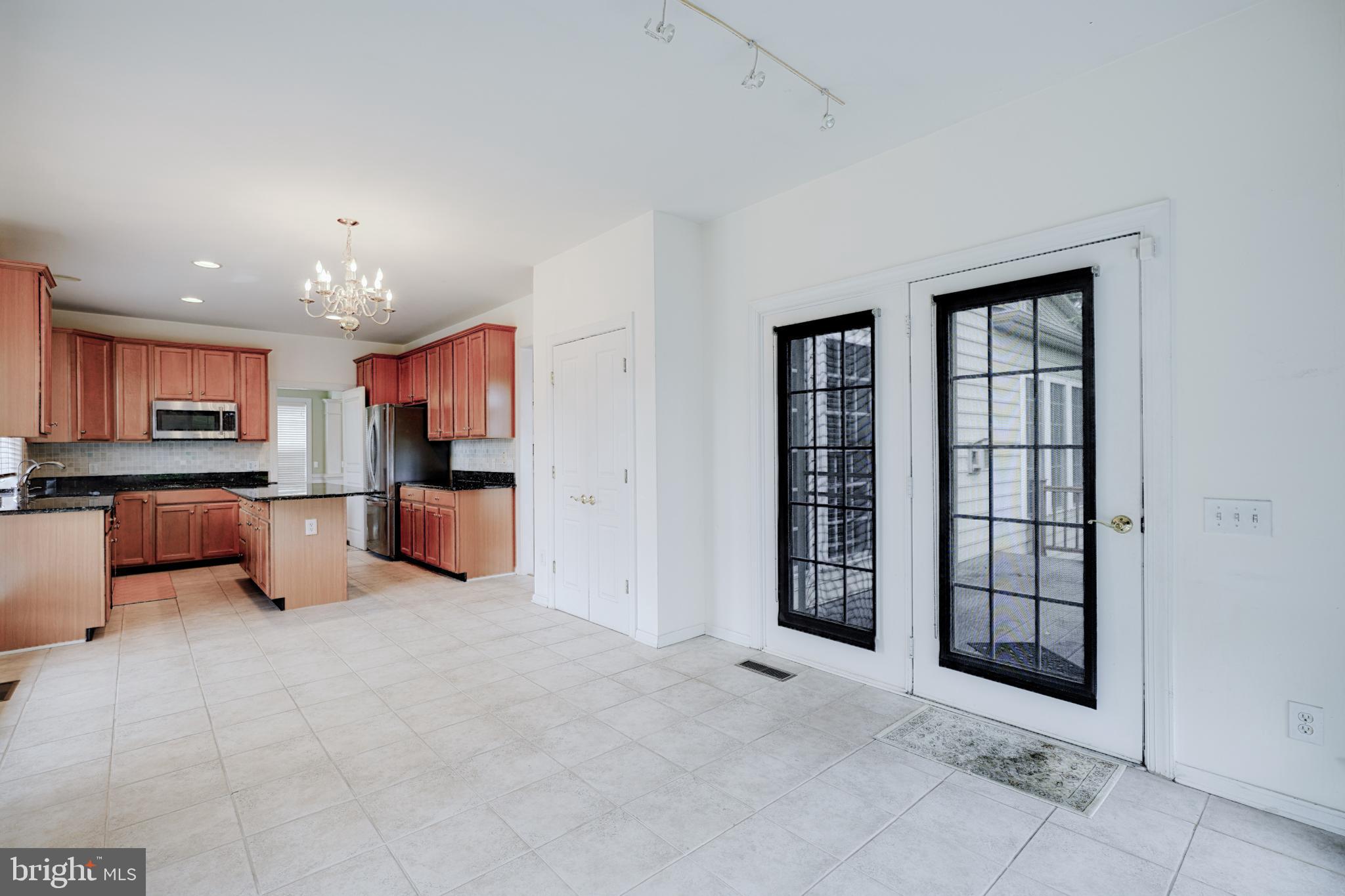 15 Ridings Way West Chester, PA 19382 - Photo 18 of 41 a large living room with stainless steel appliances kitchen island granite countertop a refrigerator and a sink