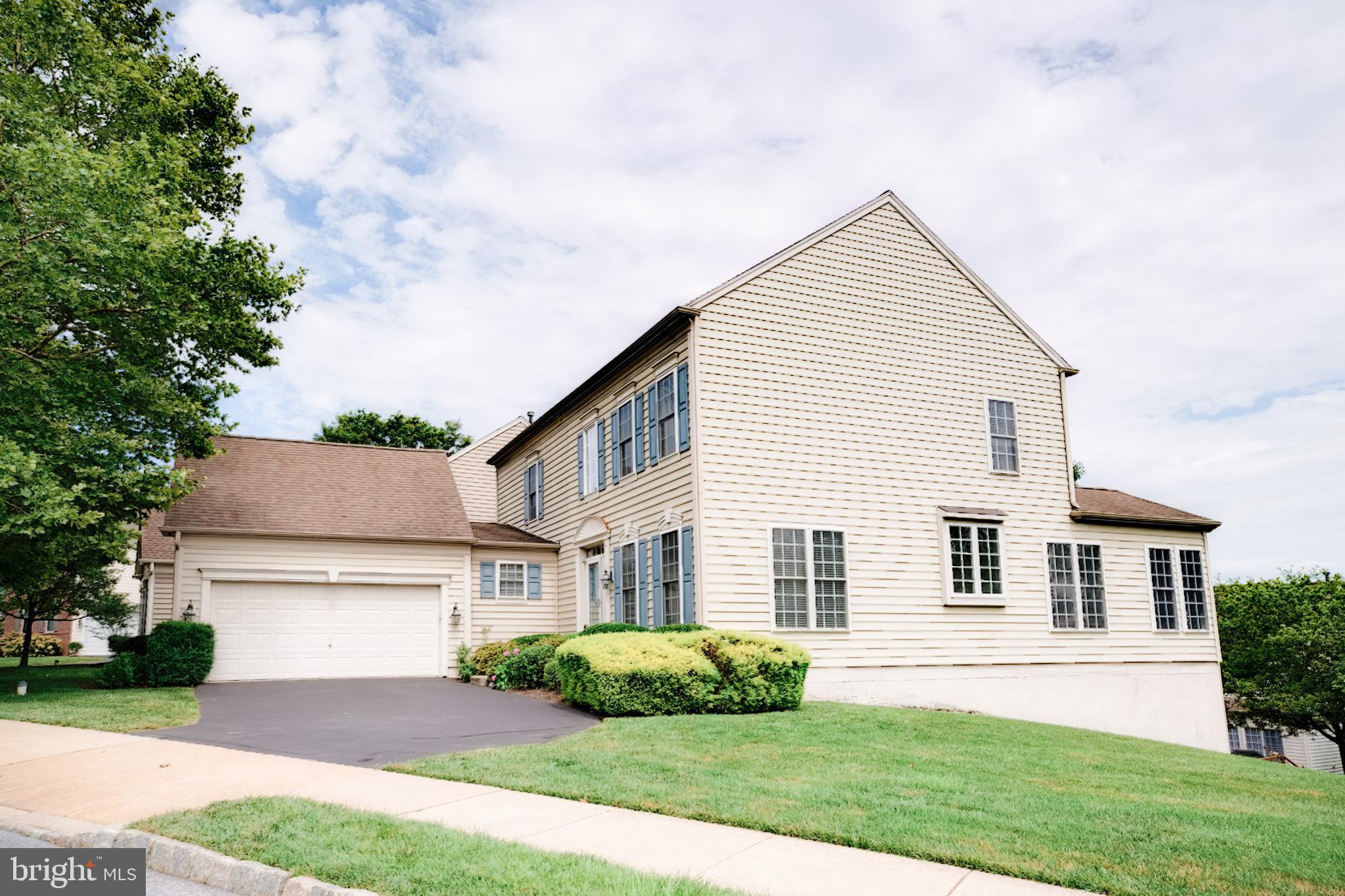 15 Ridings Way West Chester, PA 19382 - Photo 2 of 41 a front view of a house with a yard and garage