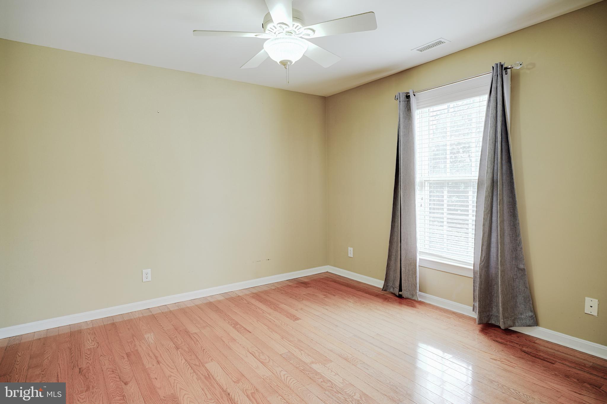 15 Ridings Way West Chester, PA 19382 - Photo 29 of 41 an empty room with a window and wooden floor