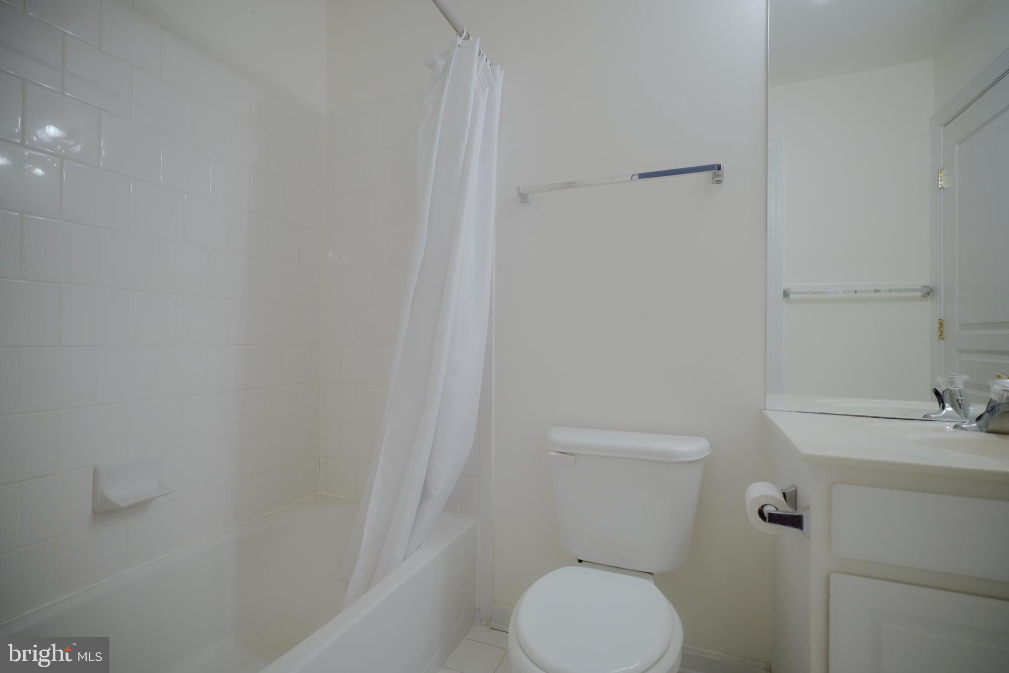 15 Ridings Way West Chester, PA 19382 - Photo 33 of 41 a white toilet sitting next to a white sink and vanity