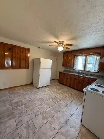 a view of a kitchen with furniture and cabinet