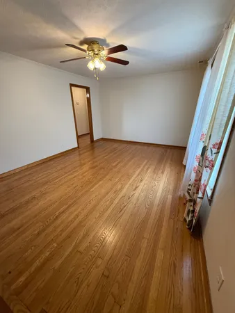 a view of a room with wooden floor