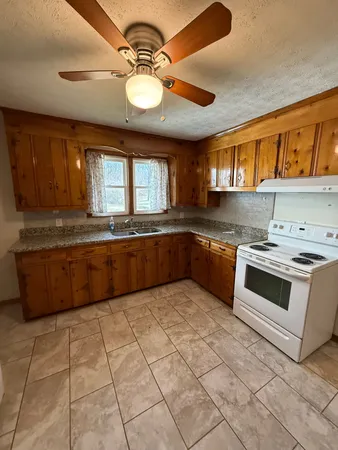 a kitchen with stainless steel appliances granite countertop a sink and cabinets