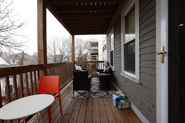 a view of balcony with wooden floor and outdoor seating