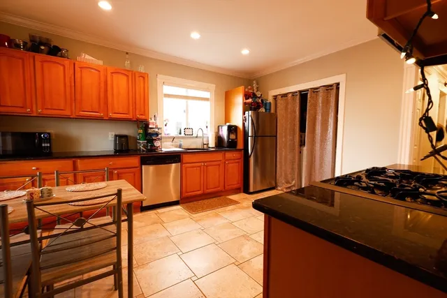 a kitchen with stainless steel appliances granite countertop a stove a sink dishwasher and a refrigerator